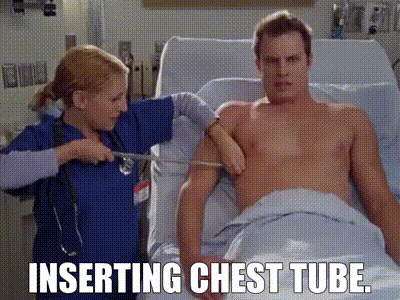 Inserting chest tube.